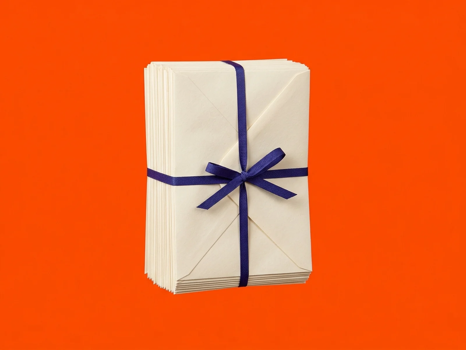 A stack of cream envelopes tied with an indigo ribbon against a solid orange background