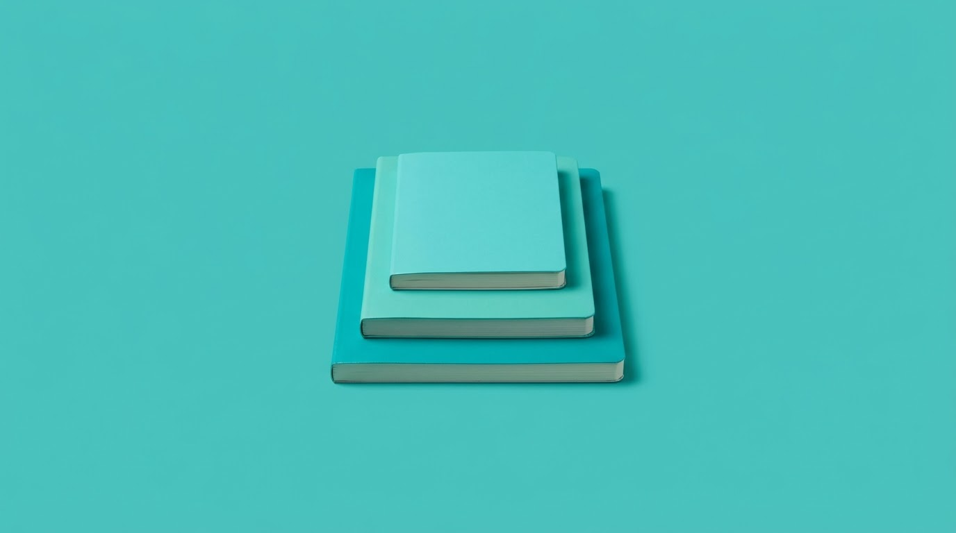 Three closed notebooks of different sizes stacked, on a teal background