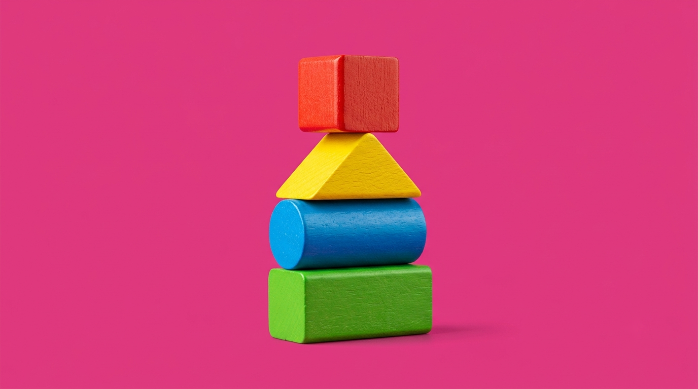 A stack of four colourful wooden building blocks, on a magenta background