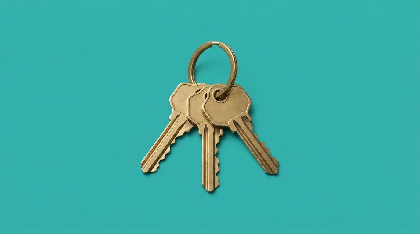 A key ring with three keys, on a teal background